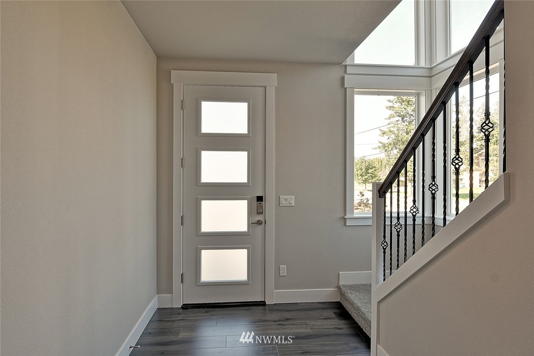 19721 1st Drive Southeast, Unit 8 Bothell, WA 98012 - Photo 2 of 28 a view of an entryway with wooden floor and stairs