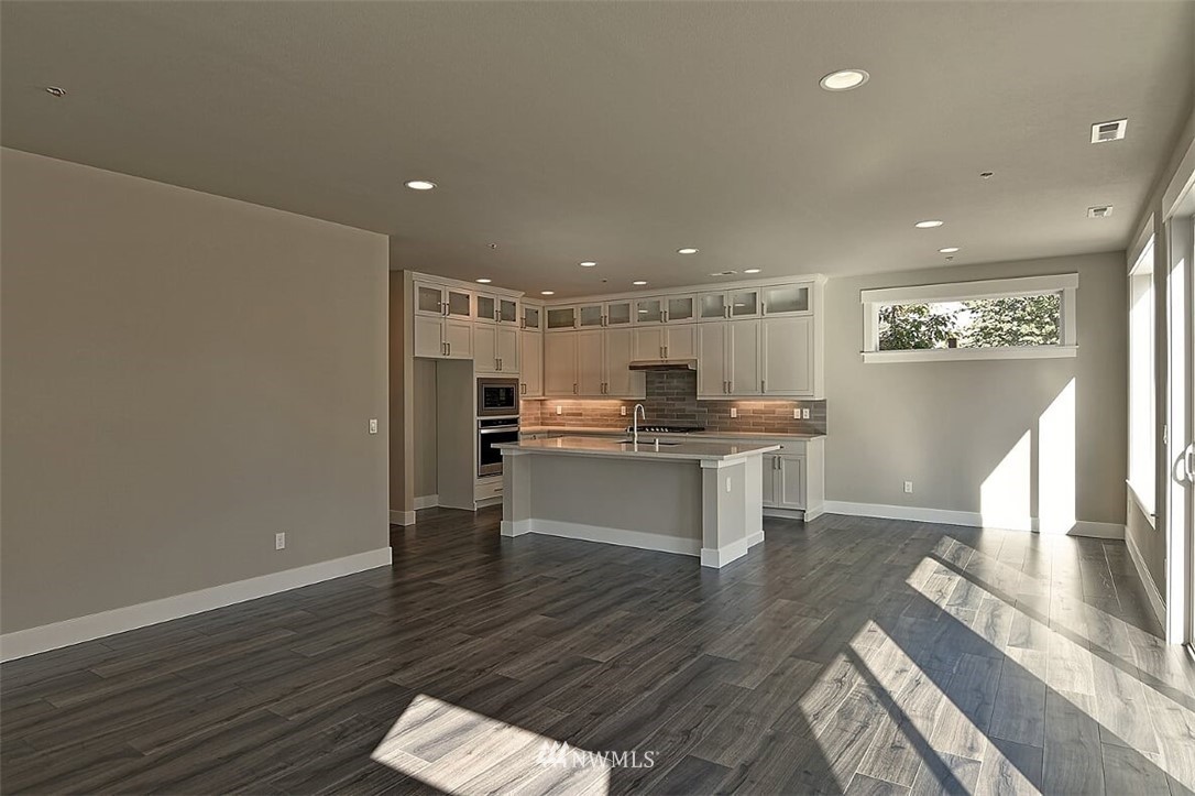 19721 1st Drive Southeast, Unit 8 Bothell, WA 98012 - Photo 12 of 28 a kitchen with a refrigerator and a stove top oven