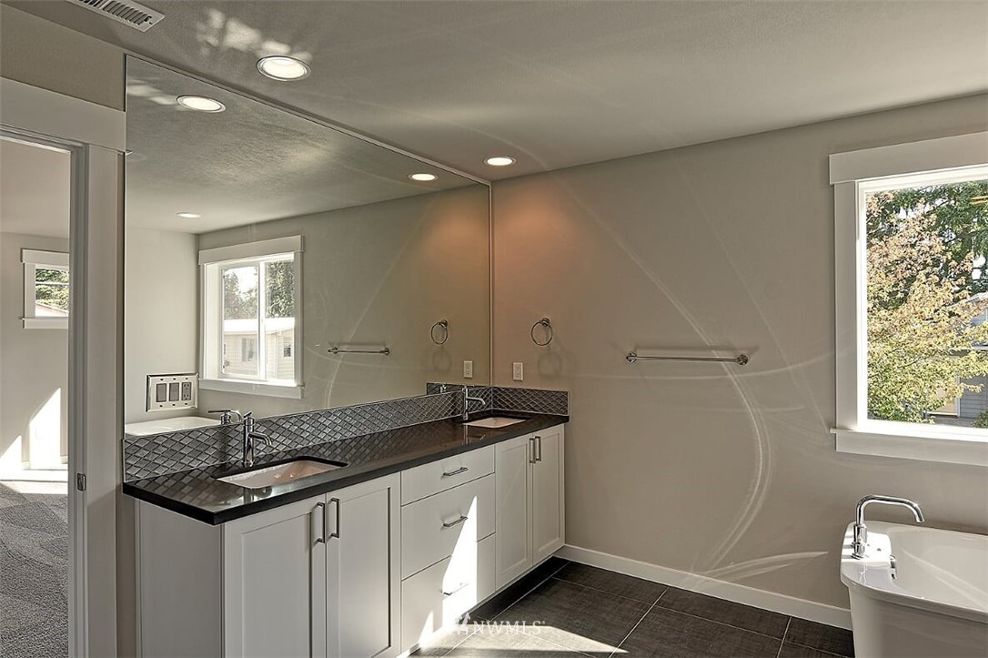 19721 1st Drive Southeast, Unit 8 Bothell, WA 98012 - Photo 16 of 28 a bathroom with a granite countertop sink and a window
