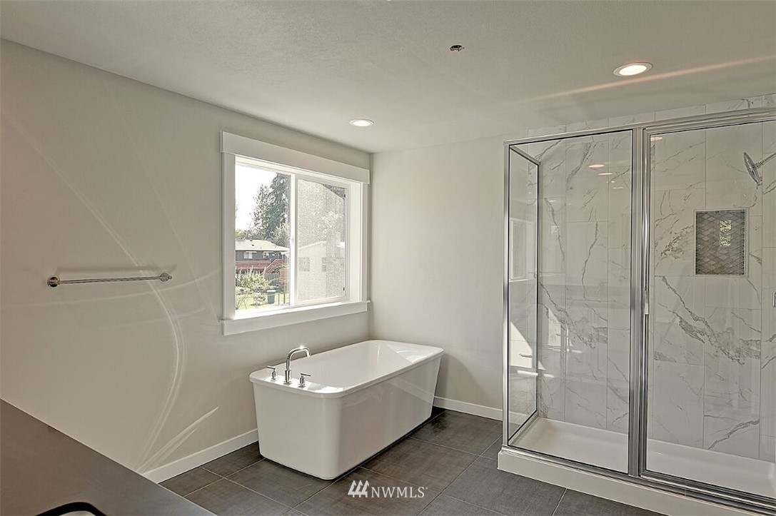 19721 1st Drive Southeast, Unit 8 Bothell, WA 98012 - Photo 17 of 28 a bathroom with a bathtub and shower