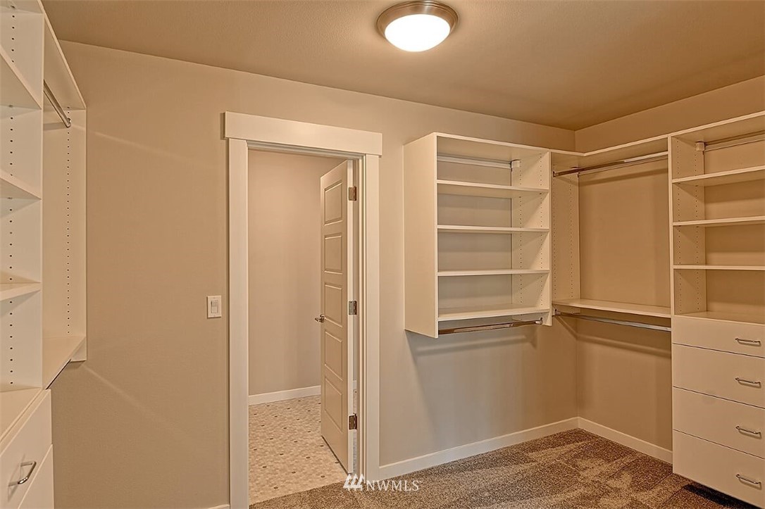 19721 1st Drive Southeast, Unit 8 Bothell, WA 98012 - Photo 18 of 28 a view of walk in closet with empty racks