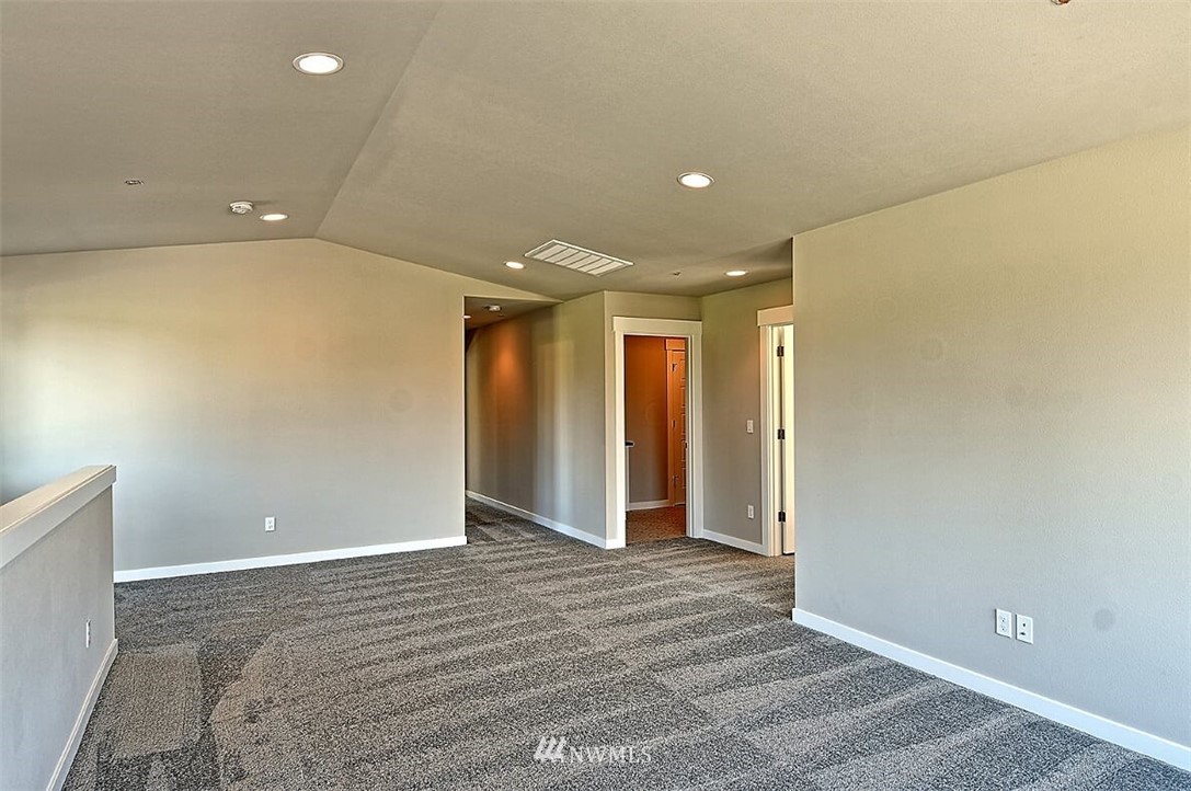 19721 1st Drive Southeast, Unit 8 Bothell, WA 98012 - Photo 21 of 28 an empty room with wooden floor and natural light