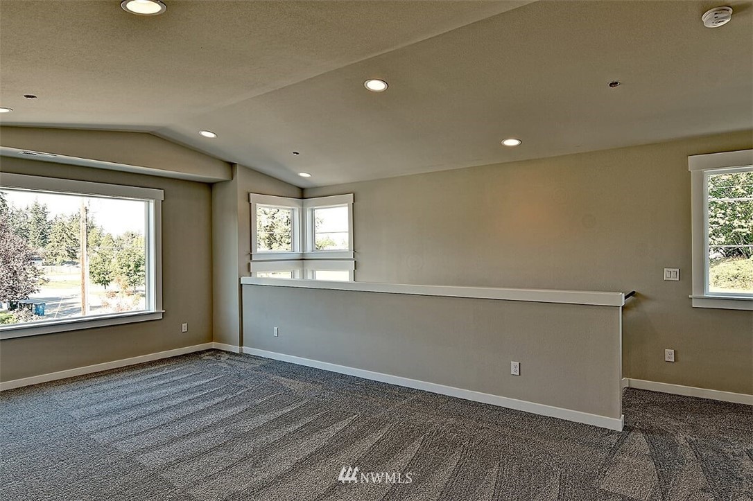 19721 1st Drive Southeast, Unit 8 Bothell, WA 98012 - Photo 22 of 28 a view of an empty room with wooden floor and a window