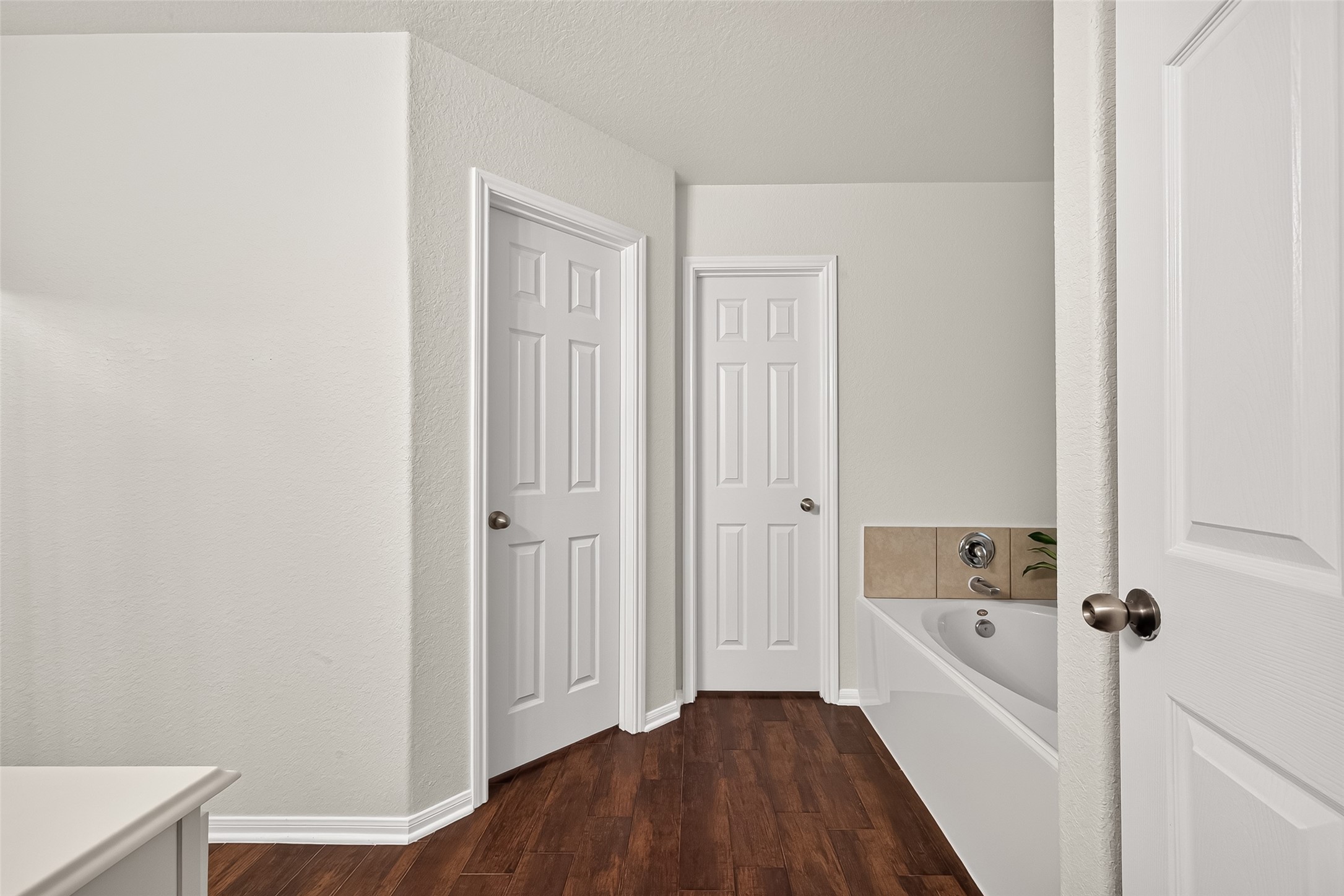 3155 View Valley Trail Katy, TX 77493 - Photo 32 of 50 Private hallway leading into the en-suite bathroom, keeping a clean, bright, and cohesive design