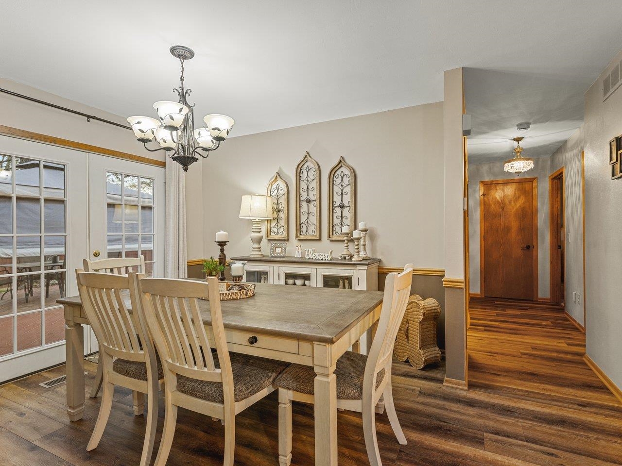 1816 Post Road Beloit, WI 53511 - Photo 10 of 42 a view of a dining room with furniture a chandelier and wooden floor