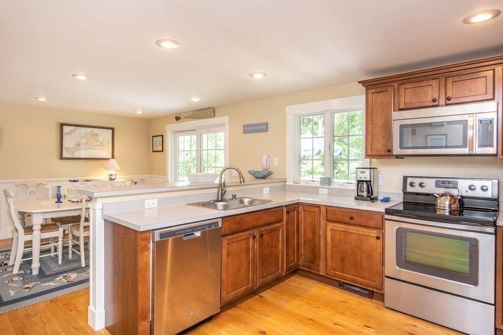 196 Springhill Road Tisbury, MA 02568 - Photo 12 of 32 a kitchen with a sink stove and cabinets