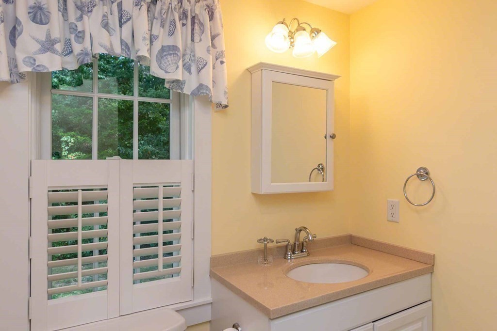 196 Springhill Road Tisbury, MA 02568 - Photo 18 of 32 a bathroom with a sink a mirror and a window