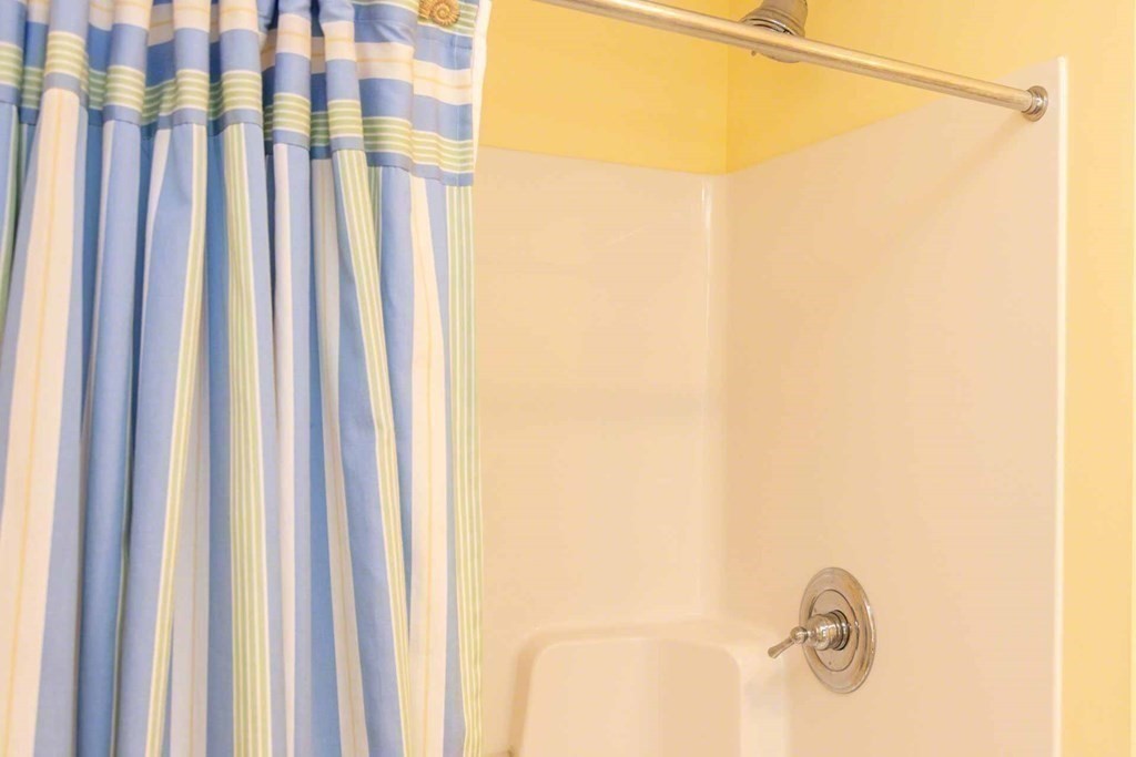 196 Springhill Road Tisbury, MA 02568 - Photo 19 of 32 a bathroom with a shower curtain and a curtain