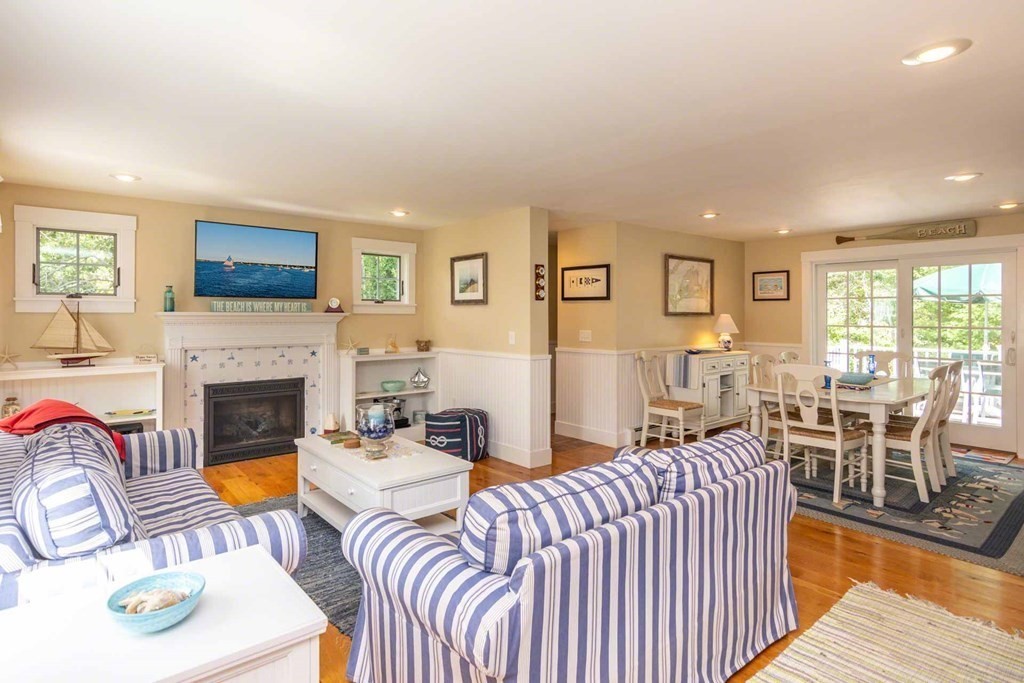 196 Springhill Road Tisbury, MA 02568 - Photo 3 of 32 a living room with furniture a fireplace and a flat screen tv