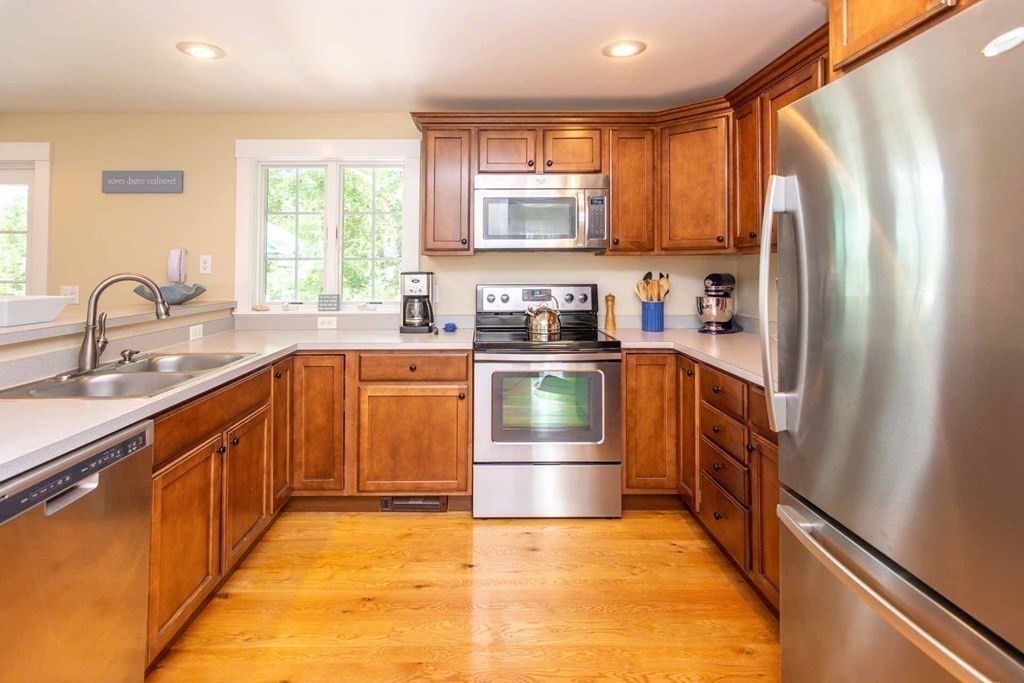 196 Springhill Road Tisbury, MA 02568 - Photo 10 of 32 a kitchen with stainless steel appliances granite countertop a refrigerator sink and stove