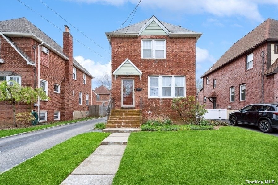 a front view of a house with a yard