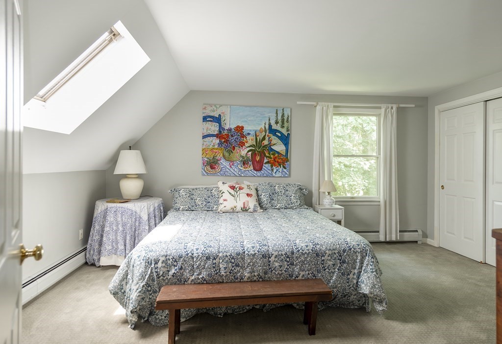 21 Mill Road Ipswich, MA 01938 - Photo 16 of 23 a bedroom with a bed and a painting on the wall