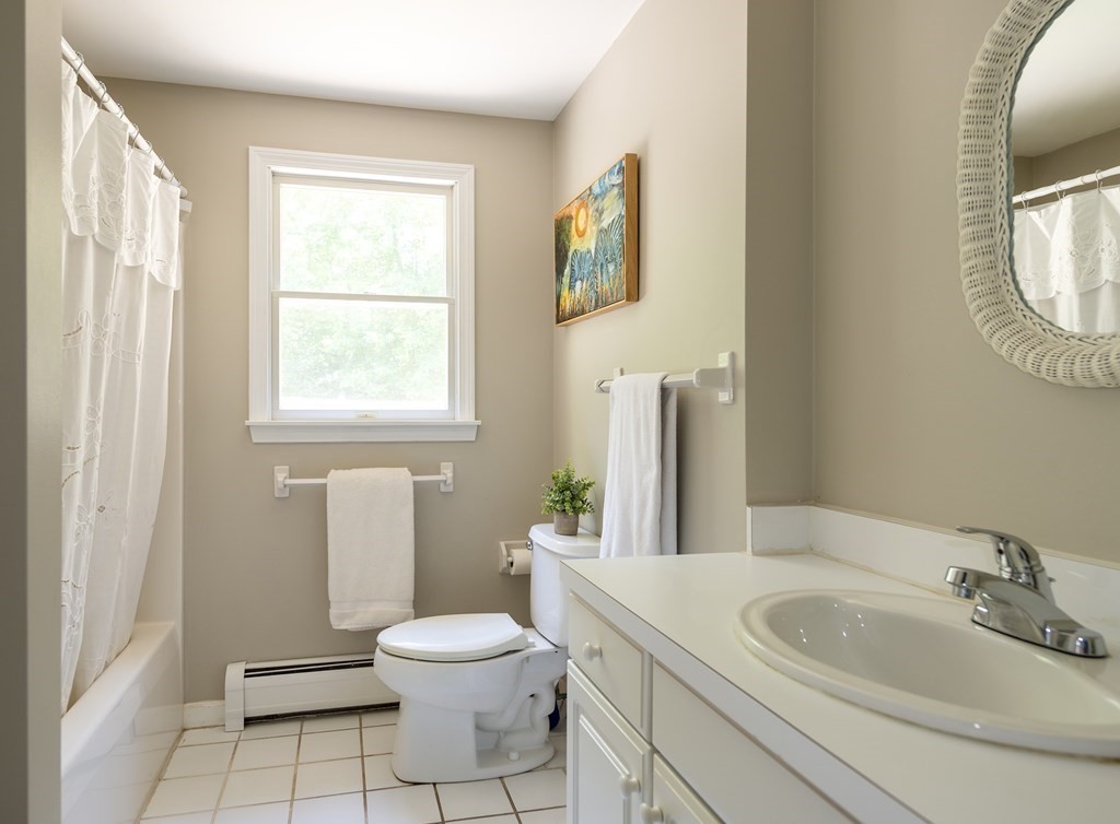 21 Mill Road Ipswich, MA 01938 - Photo 18 of 23 a bathroom with a toilet a sink and a mirror