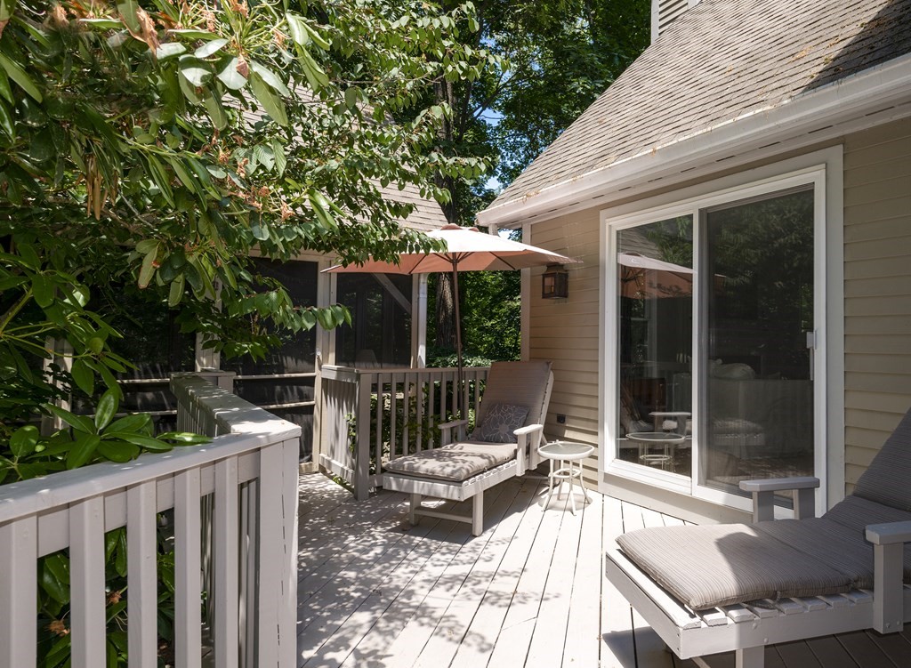 21 Mill Road Ipswich, MA 01938 - Photo 22 of 23 a view of a patio with a dining table and chairs with wooden fence and floor