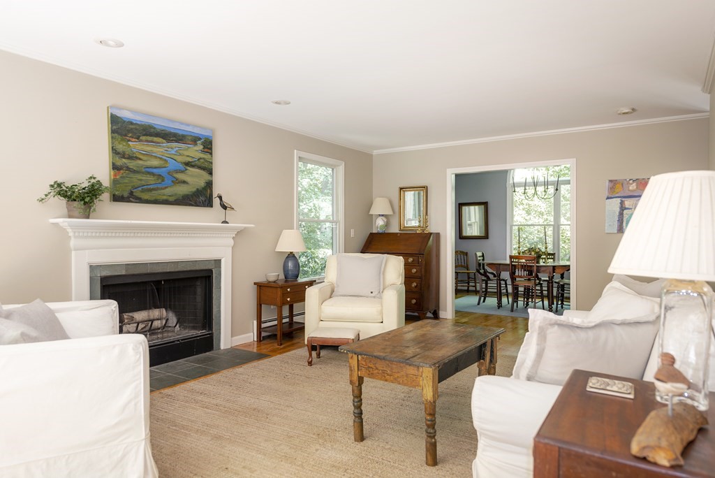 21 Mill Road Ipswich, MA 01938 - Photo 7 of 23 a living room with furniture a fireplace and a large mirror
