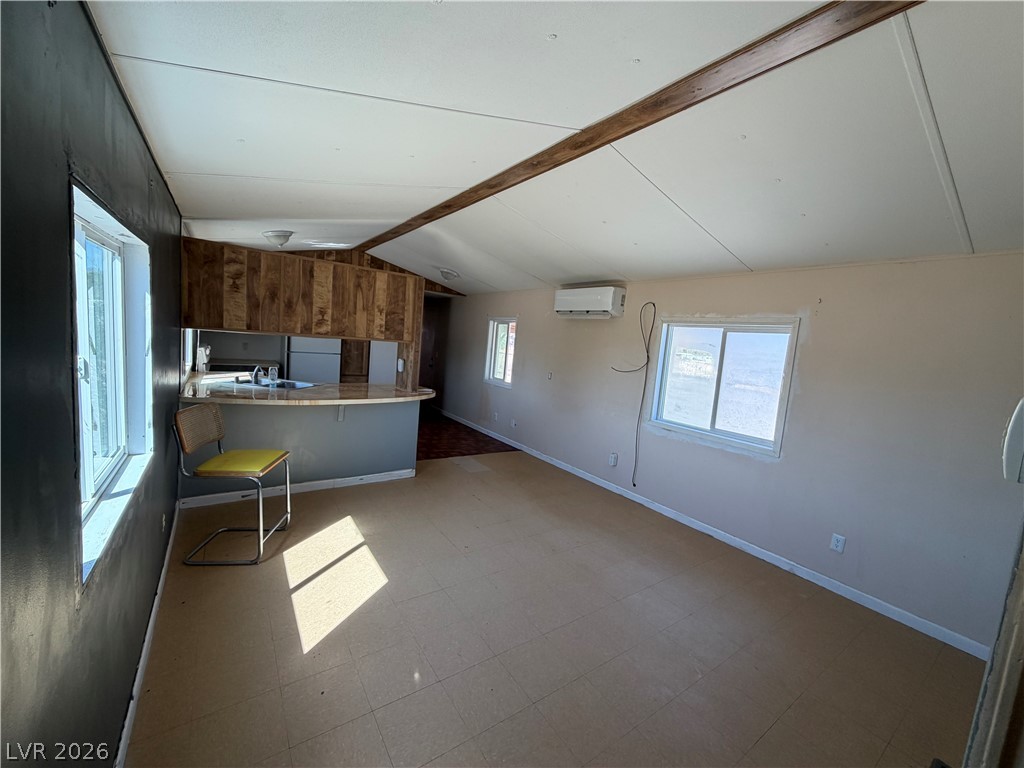 4360 Retread Road Pahrump, NV 89048 - Photo 4 of 19 An open living area connects seamlessly to the kitchen under vaulted ceilings.