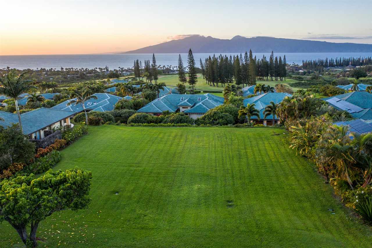 an aerial view of residential houses with outdoor space and lake view