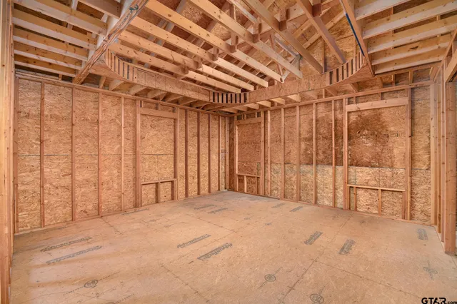 a view of a porch with wooden floor and roof with a garden view