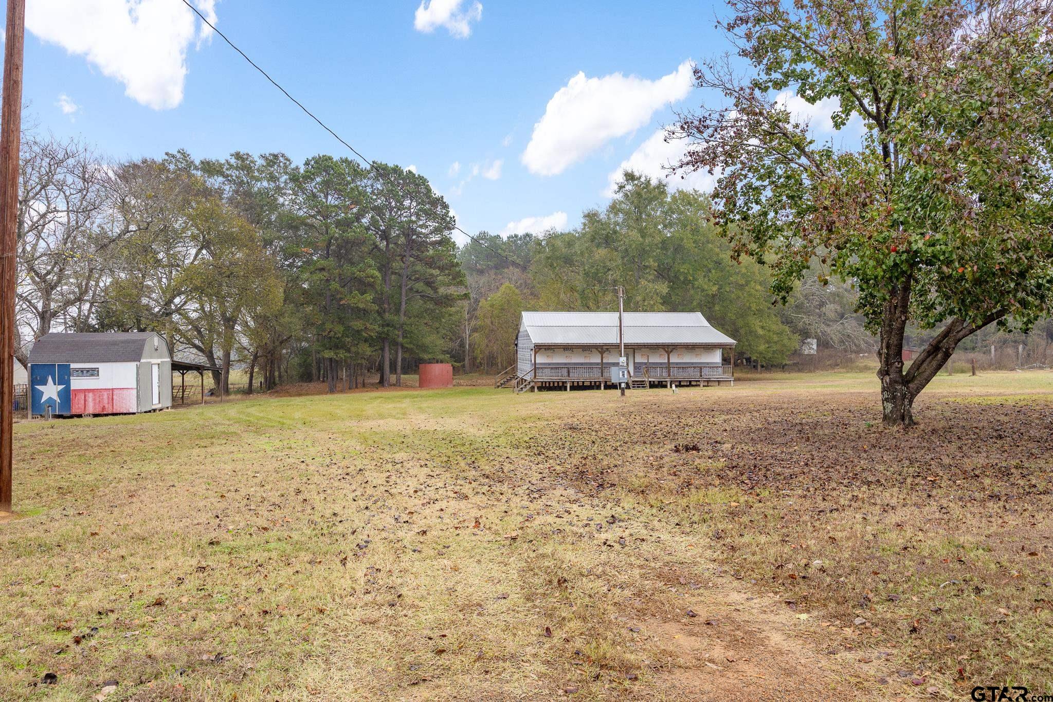 11063 County Road 2298 Tyler, TX 75707 - Photo 3 of 21 a backyard of a house with lots of green space