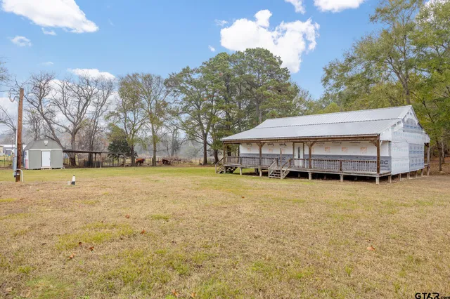 a front view of house with yard and trees