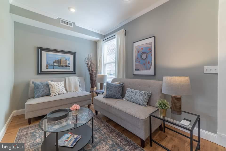 310 Marydell Road Baltimore, MD 21229 - Photo 9 of 26 a living room with furniture and a painting on the wall