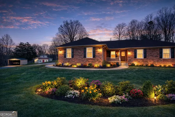 a front view of a house with a garden