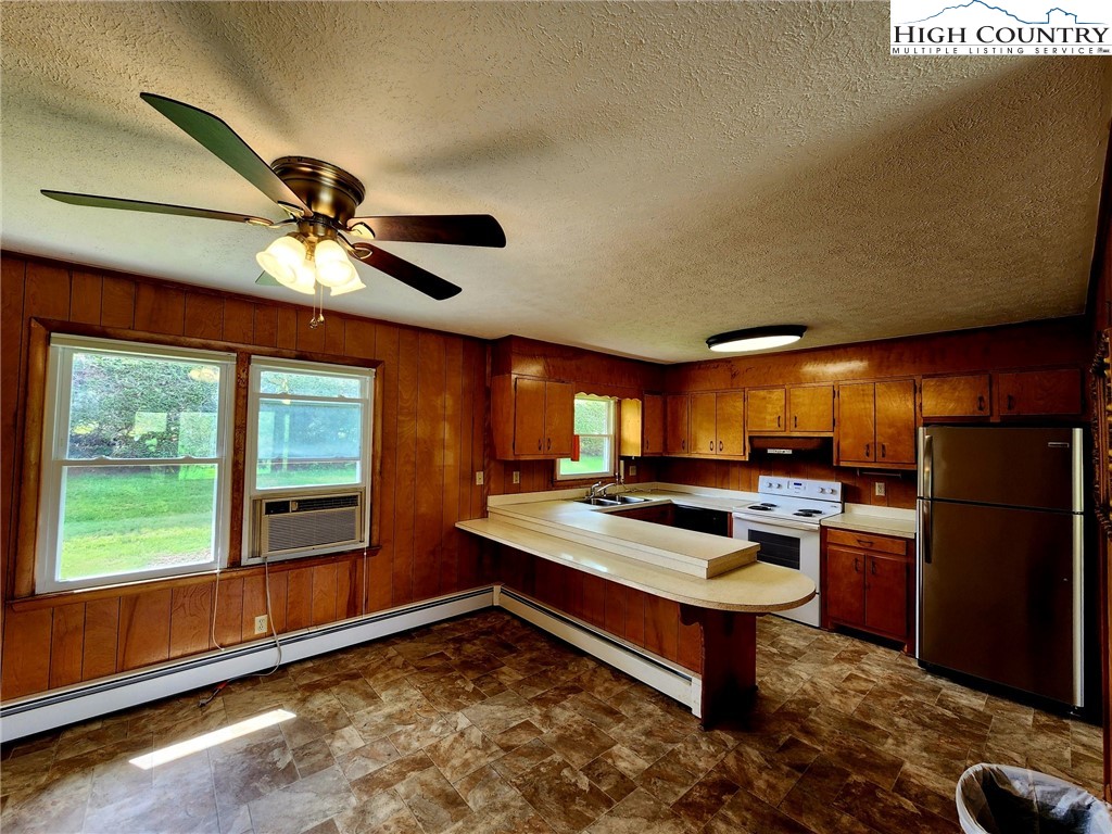130 Wheeler Street Boone, NC 28607 - Photo 20 of 40 a kitchen with a refrigerator and a stove