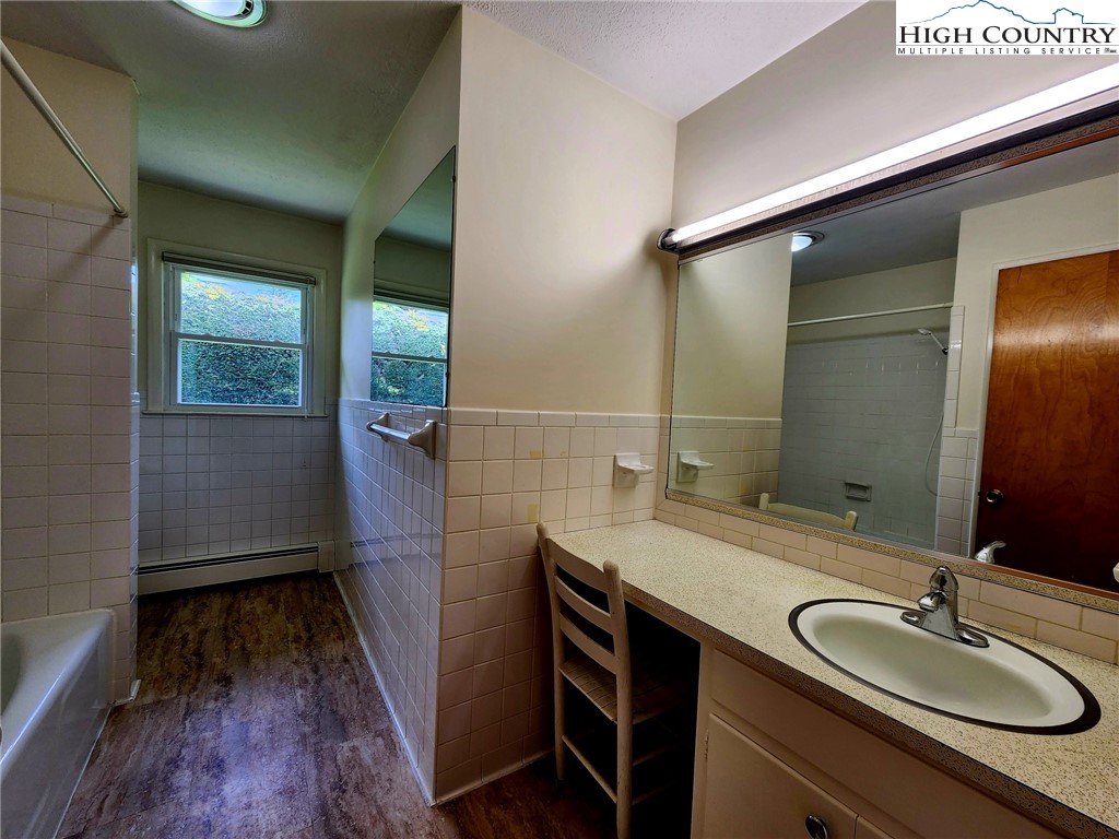 130 Wheeler Street Boone, NC 28607 - Photo 28 of 40 a bathroom with a granite countertop sink toilet and mirror