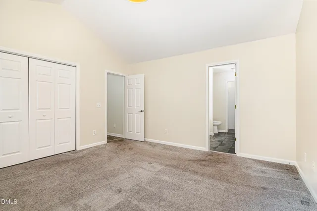 a bathroom with a granite countertop sink a toilet and a shower
