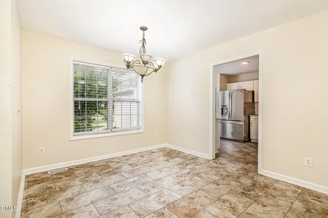 a kitchen with stainless steel appliances granite countertop a refrigerator stove and sink