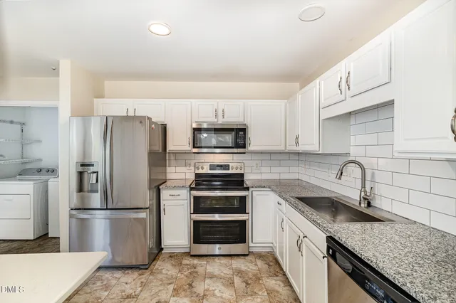 a kitchen with a refrigerator stove and sink