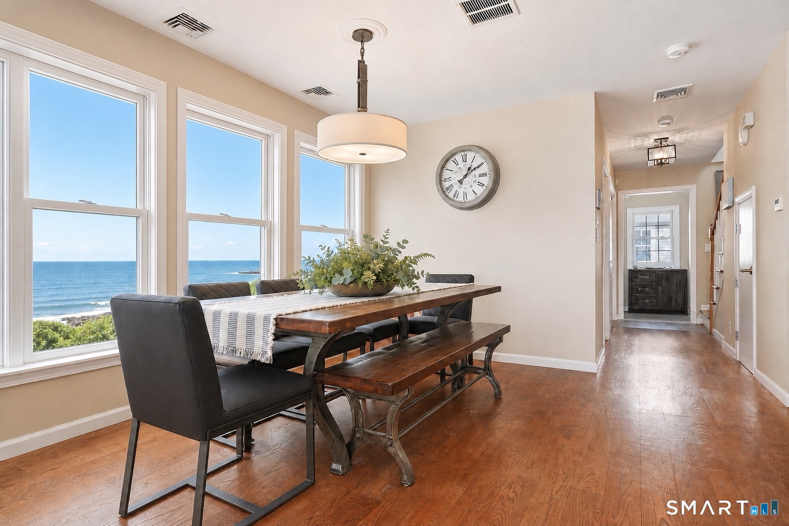 40 Pond Road Old Lyme, CT 06371 - Photo 11 of 35 a dining room with wooden floor a glass table and chairs
