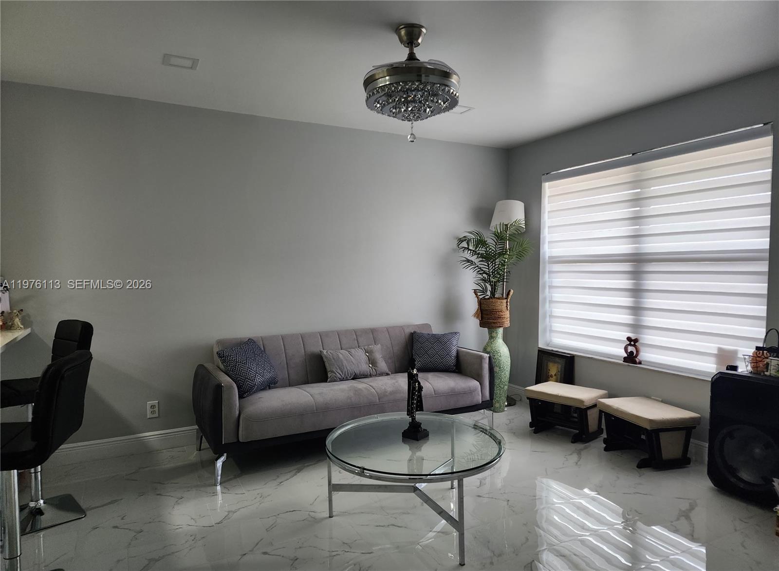 10046 Winding Lake Road, Unit 201 Sunrise, FL 33351 - Photo 3 of 12 a living room with furniture and a potted plant