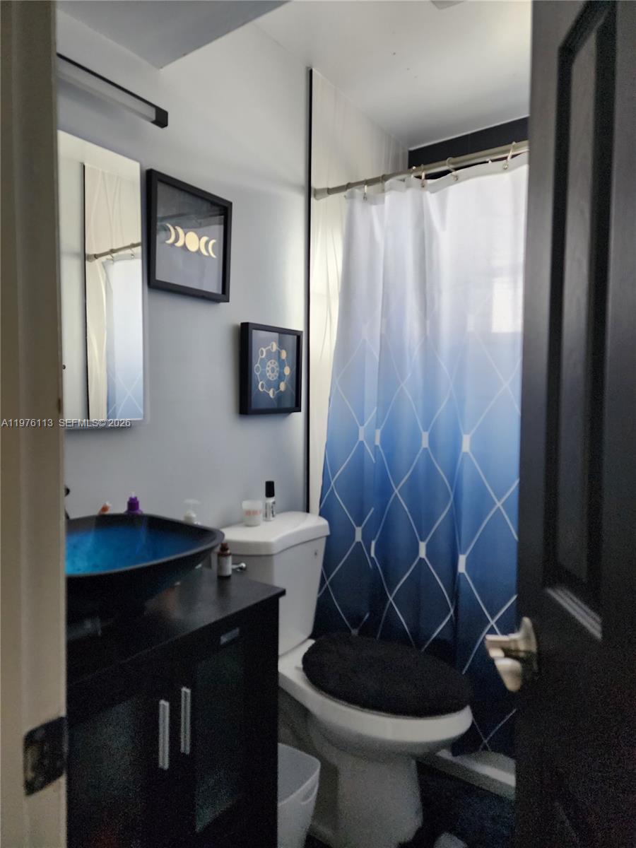 10046 Winding Lake Road, Unit 201 Sunrise, FL 33351 - Photo 6 of 12 a bathroom with a sink toilet and shower