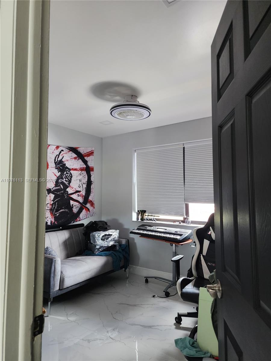 10046 Winding Lake Road, Unit 201 Sunrise, FL 33351 - Photo 7 of 12 a view of a livingroom with workspace and a window
