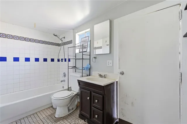 a bathroom with a sink toilet vanity and shower