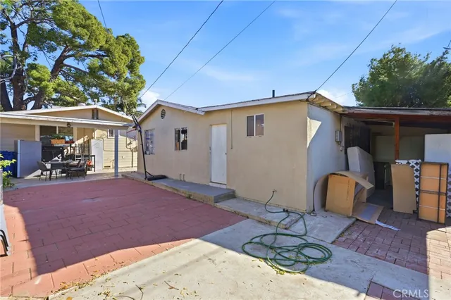 a backyard of a house with table and chairs