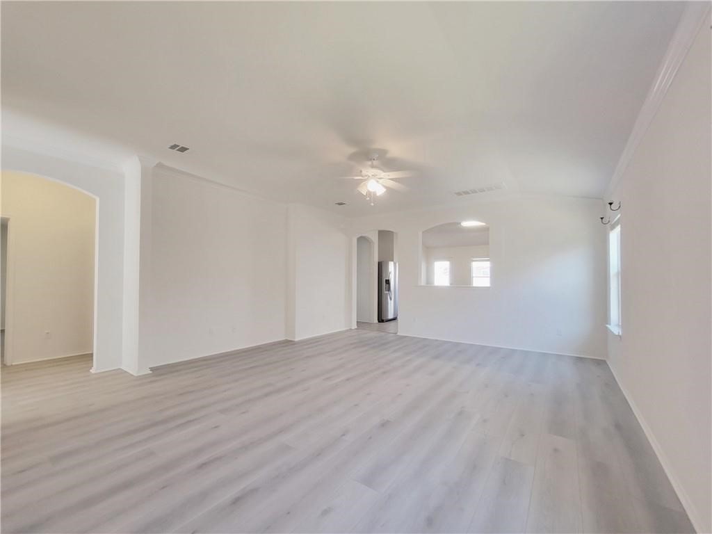 120 Inca Dove Lane Leander, TX 78641 - Photo 11 of 15 a view of an empty room with wooden floor and a window