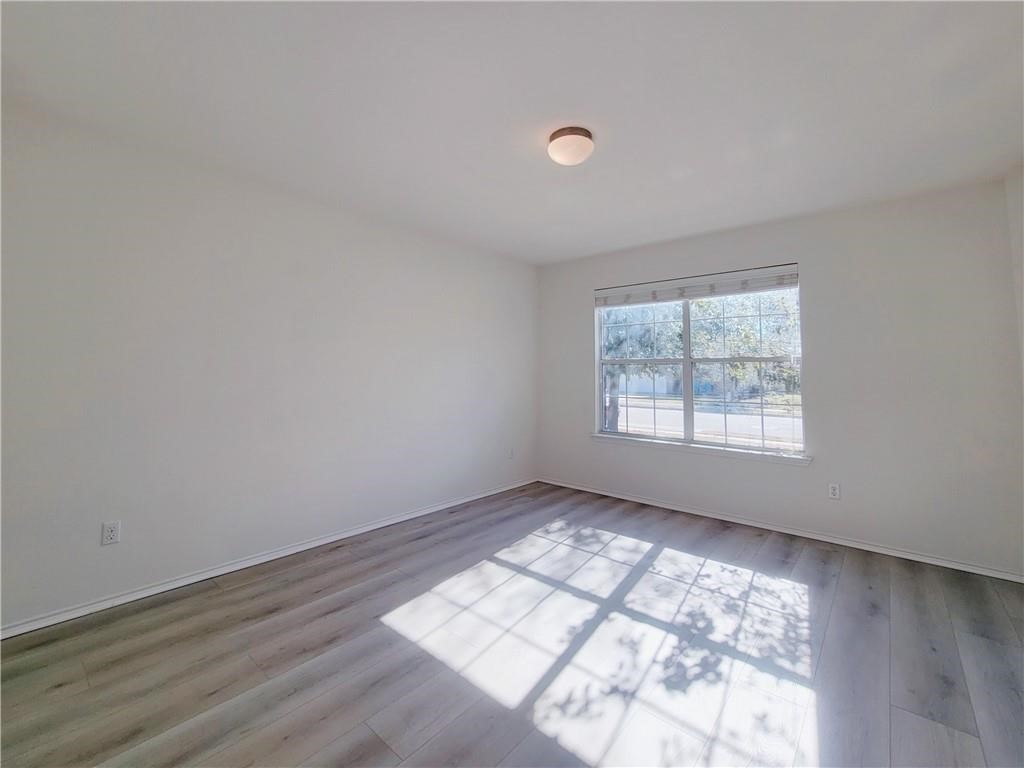 120 Inca Dove Lane Leander, TX 78641 - Photo 12 of 15 an empty room with wooden floor and windows