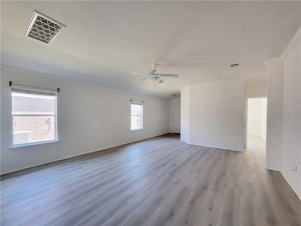 120 Inca Dove Lane Leander, TX 78641 - Photo 3 of 15 an empty room with wooden floor and windows