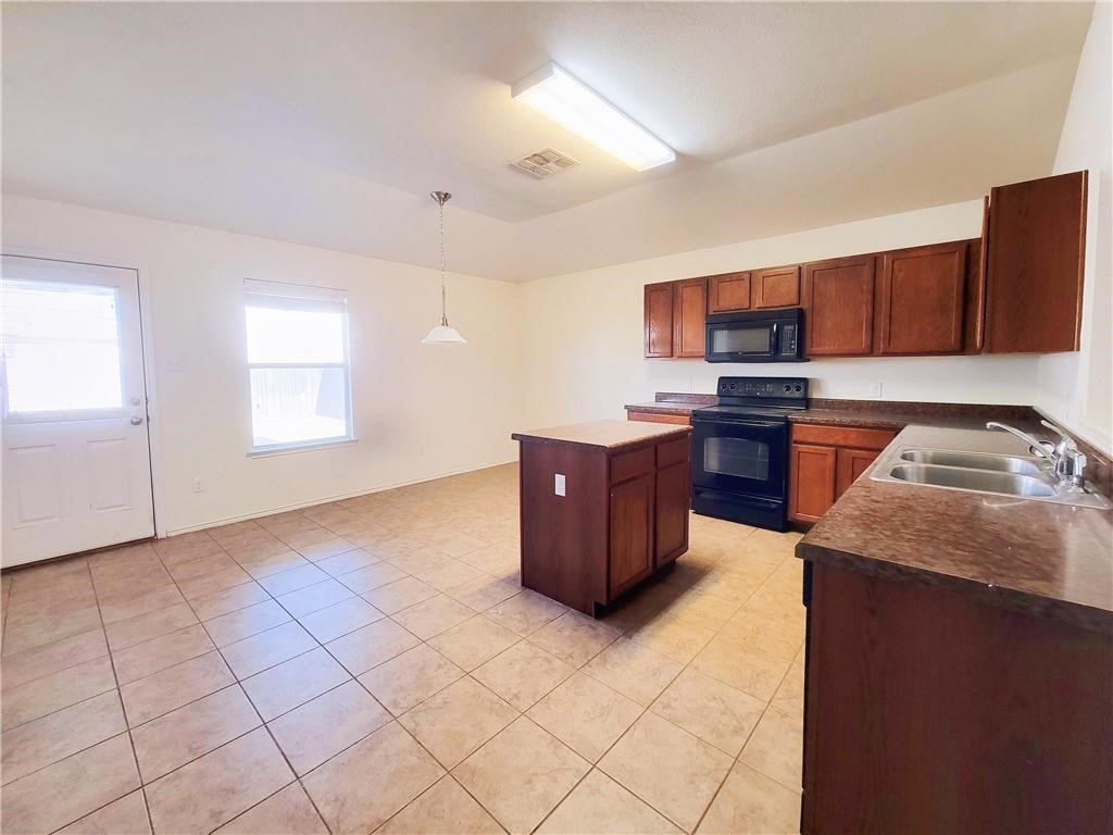 120 Inca Dove Lane Leander, TX 78641 - Photo 4 of 15 a kitchen with stainless steel appliances granite countertop a stove a sink and a refrigerator