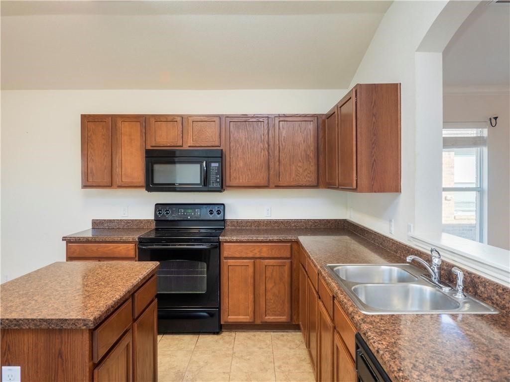 120 Inca Dove Lane Leander, TX 78641 - Photo 6 of 15 a kitchen with granite countertop a stove and a sink