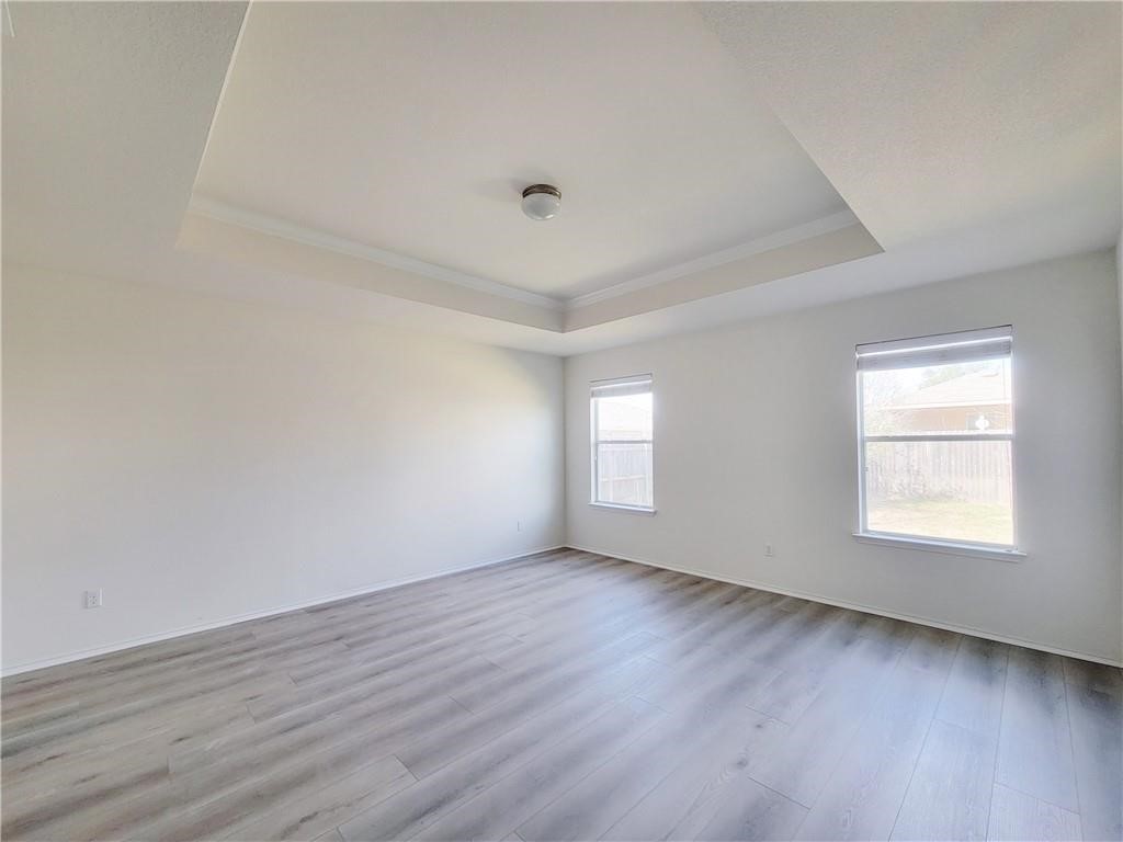 120 Inca Dove Lane Leander, TX 78641 - Photo 9 of 15 an empty room with wooden floor and windows