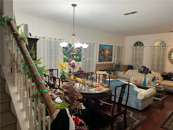 a view of a dining room with furniture wooden floor and chandelier