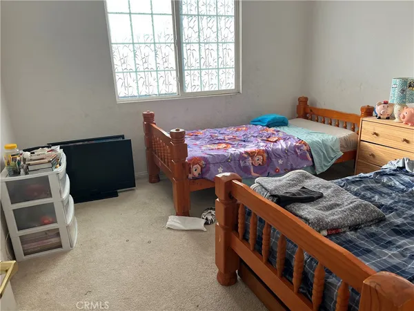 a bedroom with bed and a window