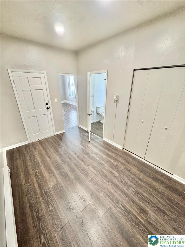 540 Montclair Avenue, Unit 1 Bethlehem, PA 18015 - Photo 3 of 9 an empty room with wooden floor and windows