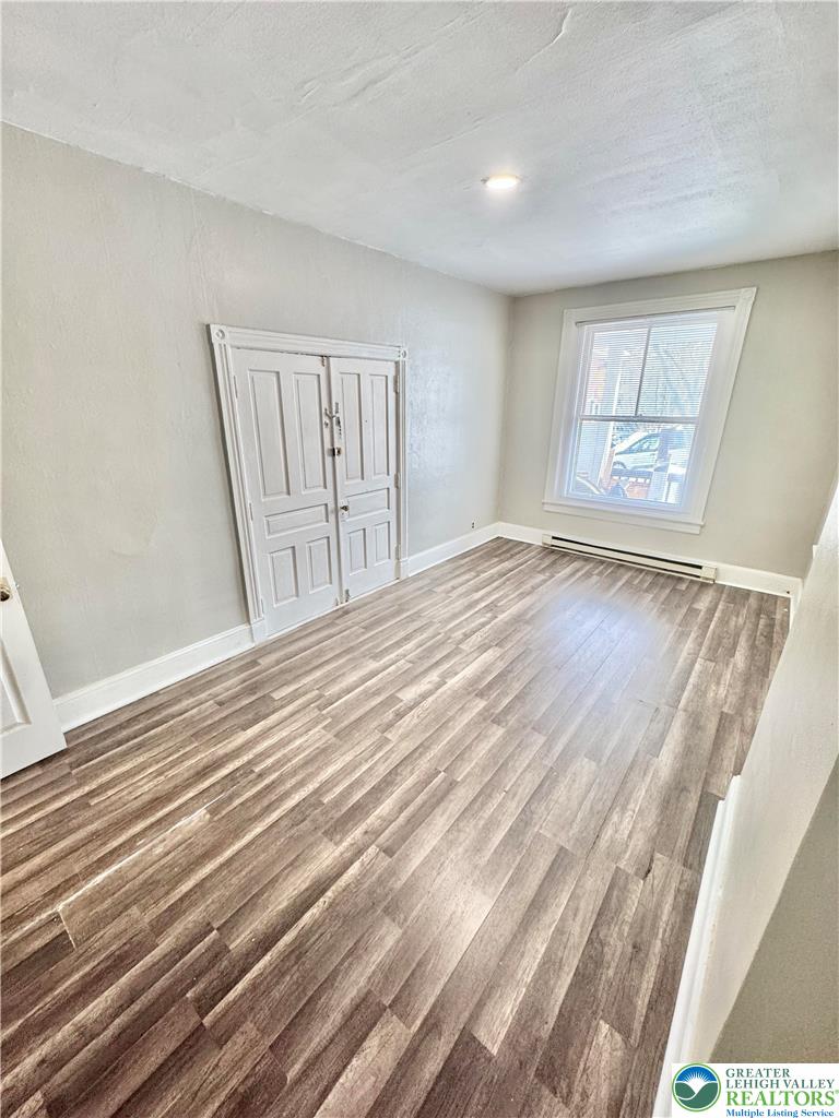 540 Montclair Avenue, Unit 1 Bethlehem, PA 18015 - Photo 4 of 9 a view of an empty room with wooden floor and a window