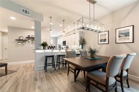 a kitchen with sink cabinets and dining table chair