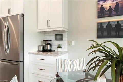 a dining room with furniture large windows and wooden floor