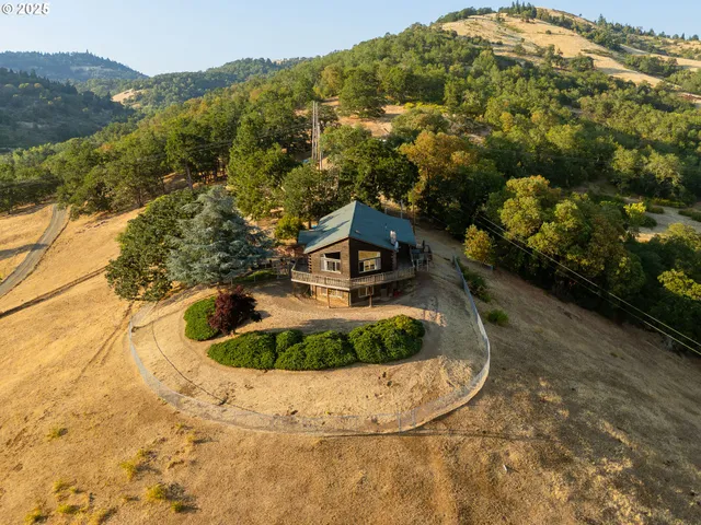 a view of a house with a yard and sitting area